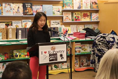 Student reads poem to crowd